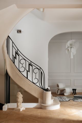 An eye catching entrance with a sculptural staircase