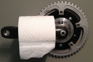 A toilet paper dispenser made from an old bicycle crankarm