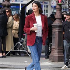 Kendall Jenner wears a red blazer, white t-shirt, jeans and burgundy lug-sole loafers.