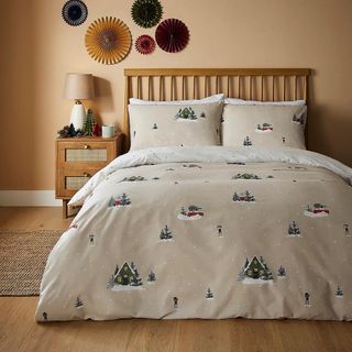 Cream bedding set with Christmas trees and snow scenes on it