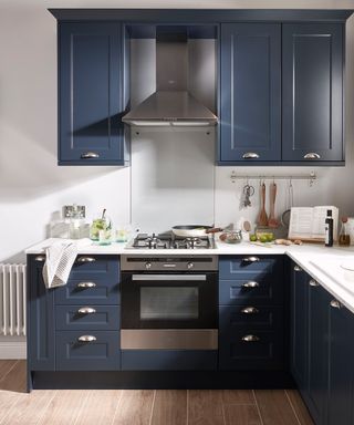 navy blue kitchen with under cabinet trim