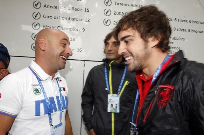 Paolo Bettini chats with Fernando Alonso at the 2013 road cycling world championships in Italy