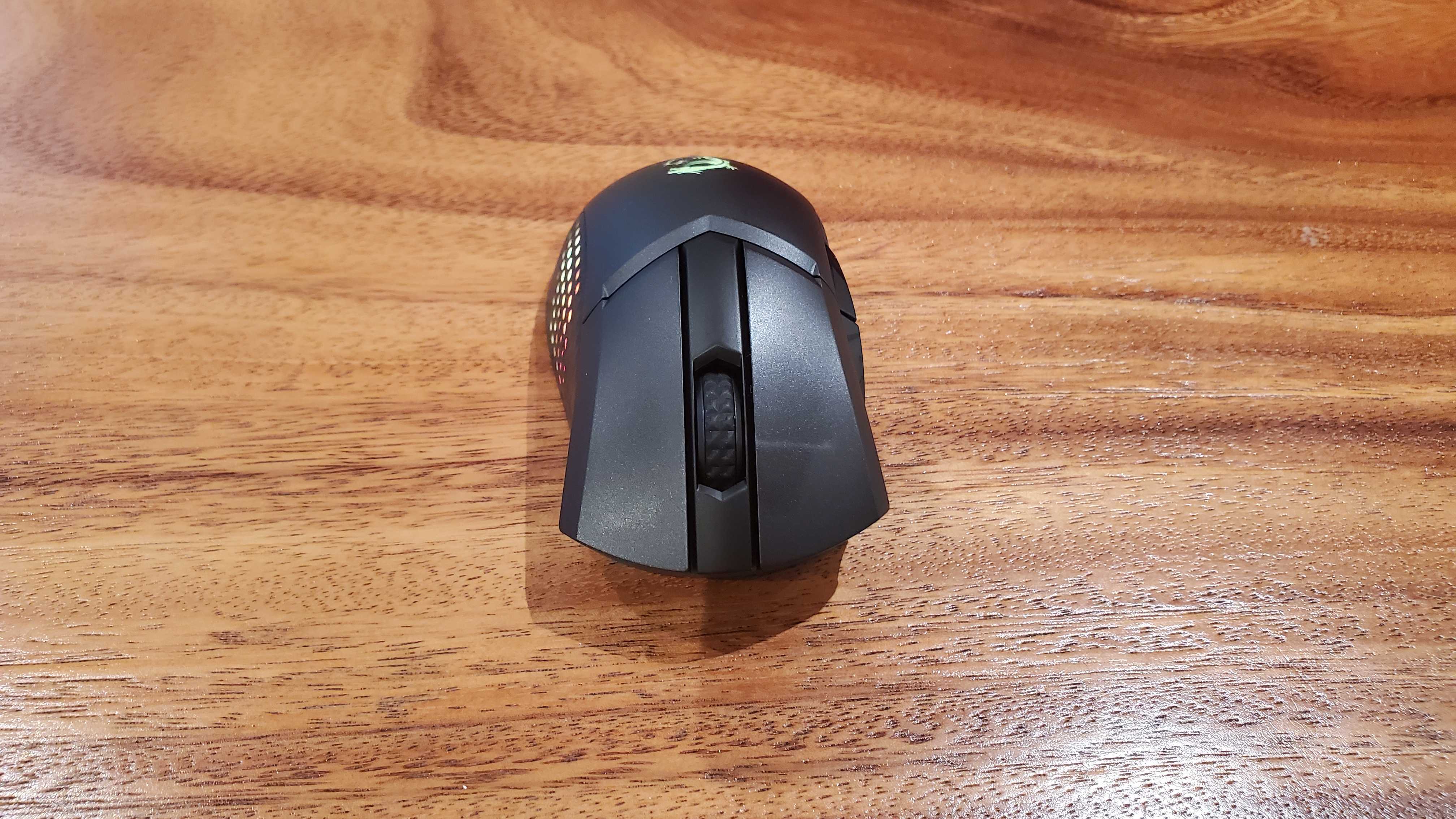 black gaming mouse on a wooden table
