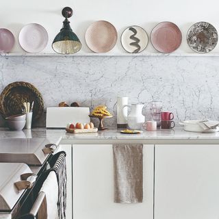 A kitchen with a plate display