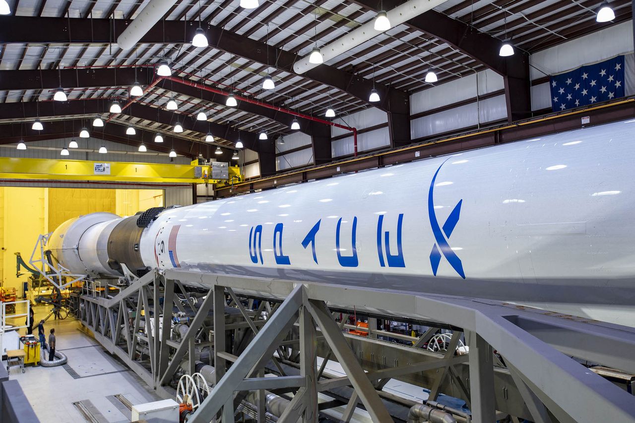 SpaceX workers prepare a new Falcon 9 rocket to launch the advanced GPS III SV03 satellite from Cape Canaveral Air Force Station for the U.S. Space Force.