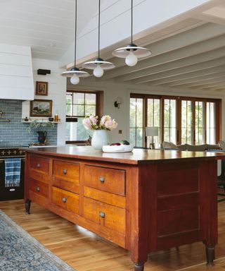 An antique kitchen island made of wood.