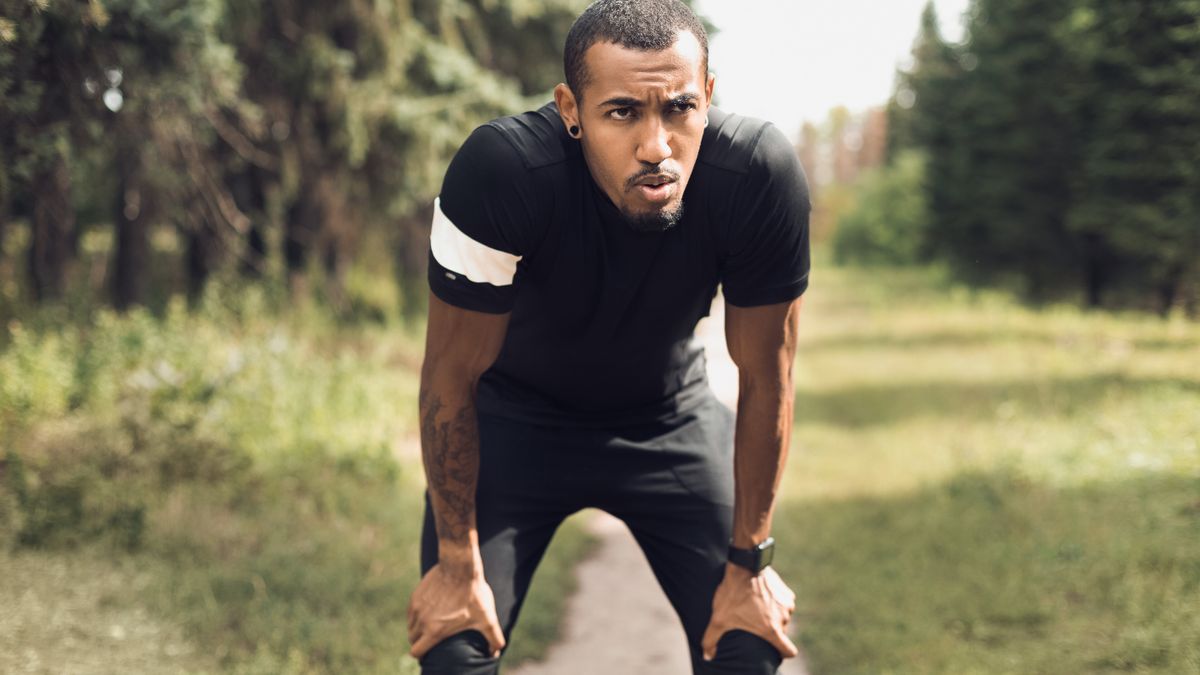 Man pausing for a break while running outdoors