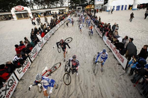 The riders dismount to navigate a particularly thick section of sand.