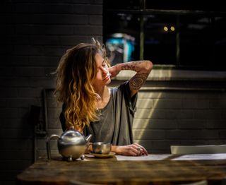 Woman sat at a desk looking tired