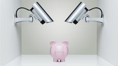 A piggy bank sits under security spotlights.