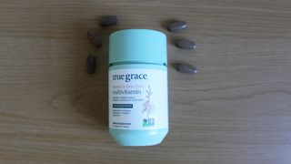 Container of True Grace One Daily Women’s Multivitamin 40+ on a table