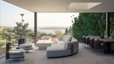 An outdoor living room with a curved sofa, rope chairs, an outdoor dining set, a skylight, and a white fire pit