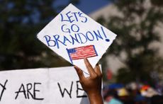 A protestor holds a 'Let's Go Brandon!' sign in Los Angeles