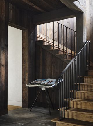 rustic staircase with reclaimed wood and modern metal balustrade by Ryan Street Interiors
