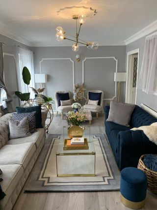 grey formal living room with brass chandelier