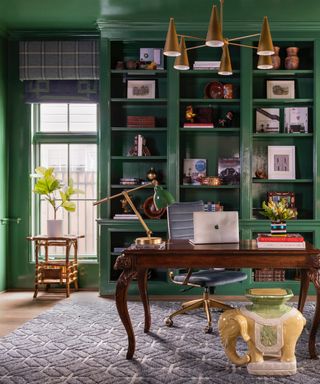 design a home that feels like you, green home office with gloss green custom bookcase with books and objet, mahogany desk, grey rug, retro pendant, lamps