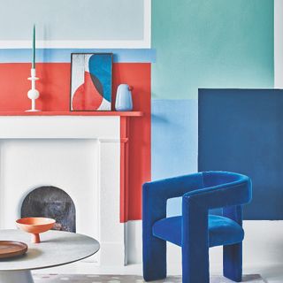 painted wall with fireplace and blue velvet chair