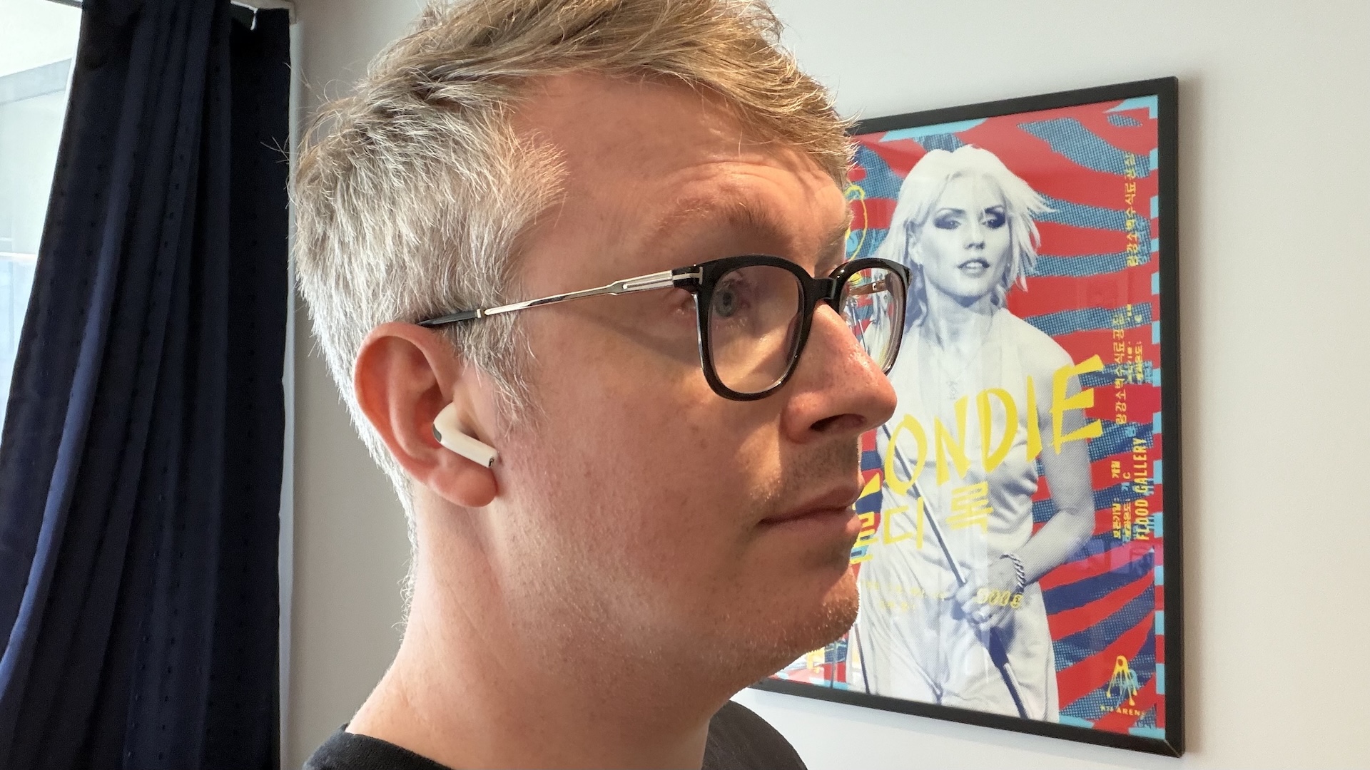 The AirPods Pro 3 earbuds from Apple against the pages of a graphic novel.