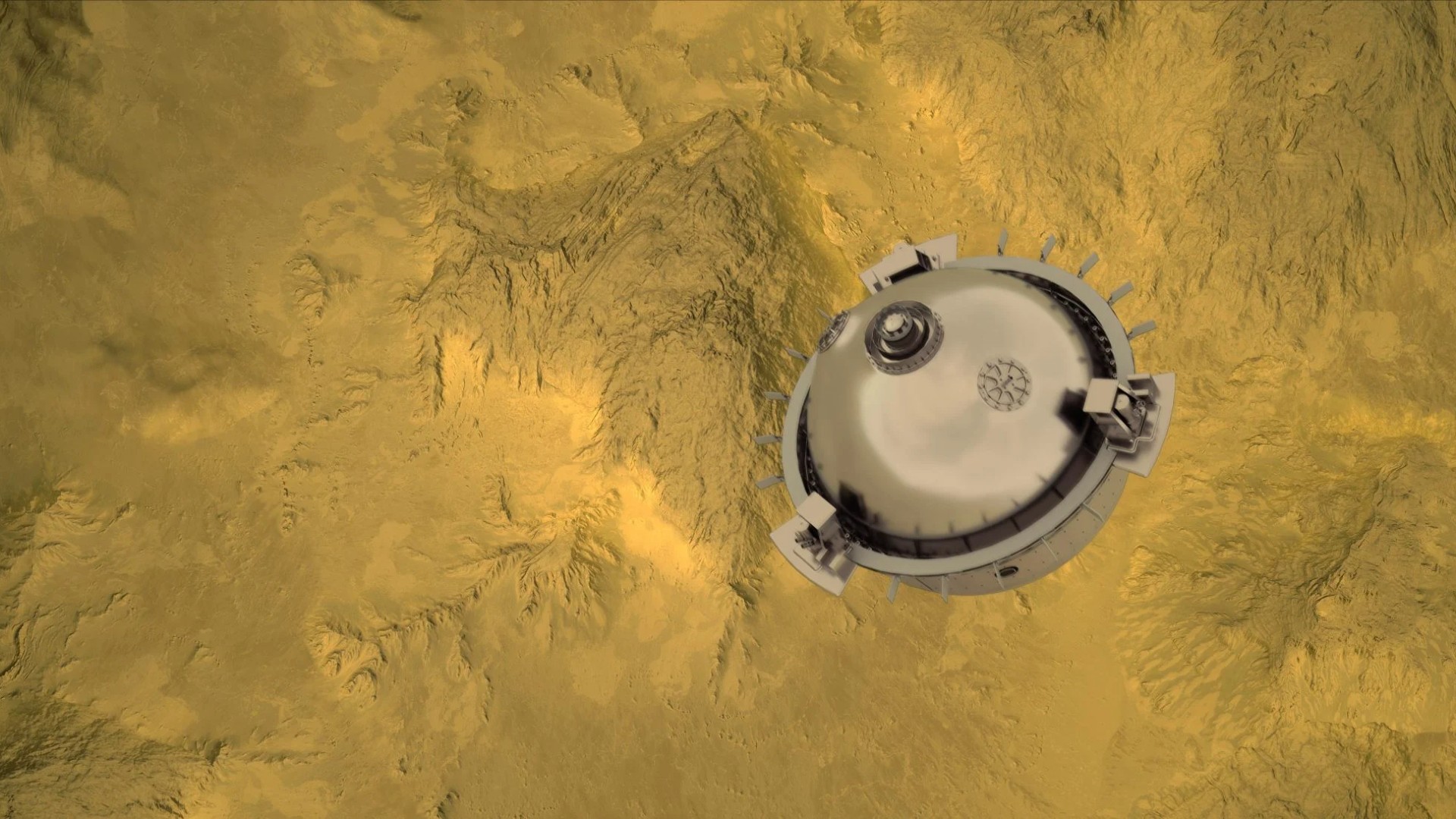 a silver spherical probe above a yellow-and-grey mountainous landscape, as seen from far above