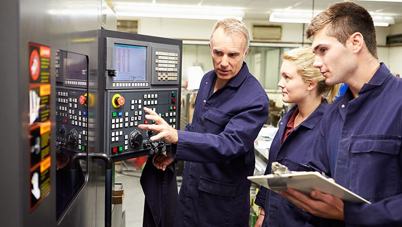 An engineer showing around two apprentices