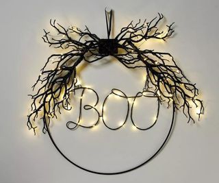 A light-up Halloween wall ornament in the shape of a bauble. The lights spell out 'BOO'.
