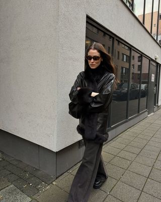 Fashion influencer wearing an all-black outfit.