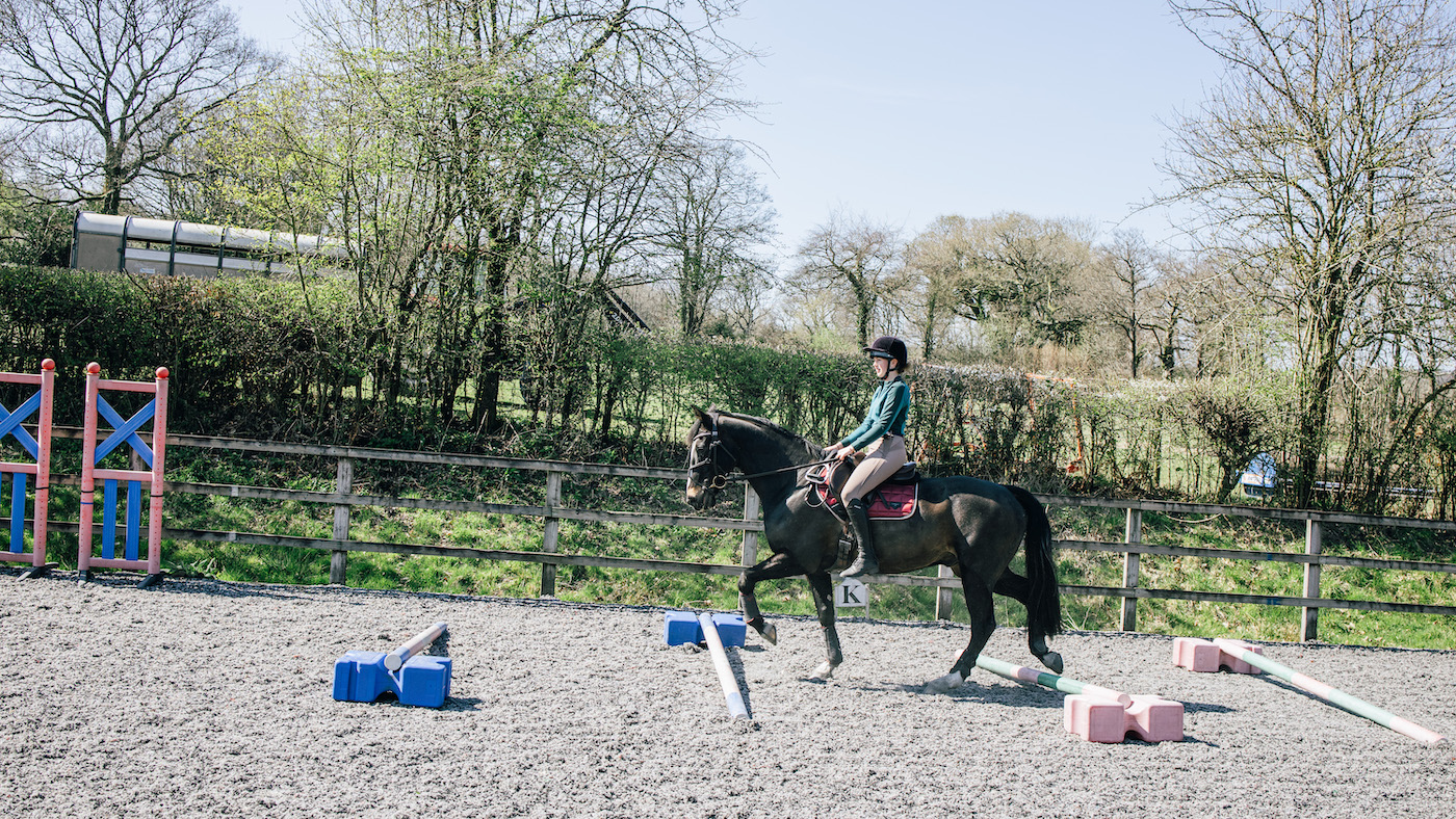 Rider walking over raised poles as a balance exercise