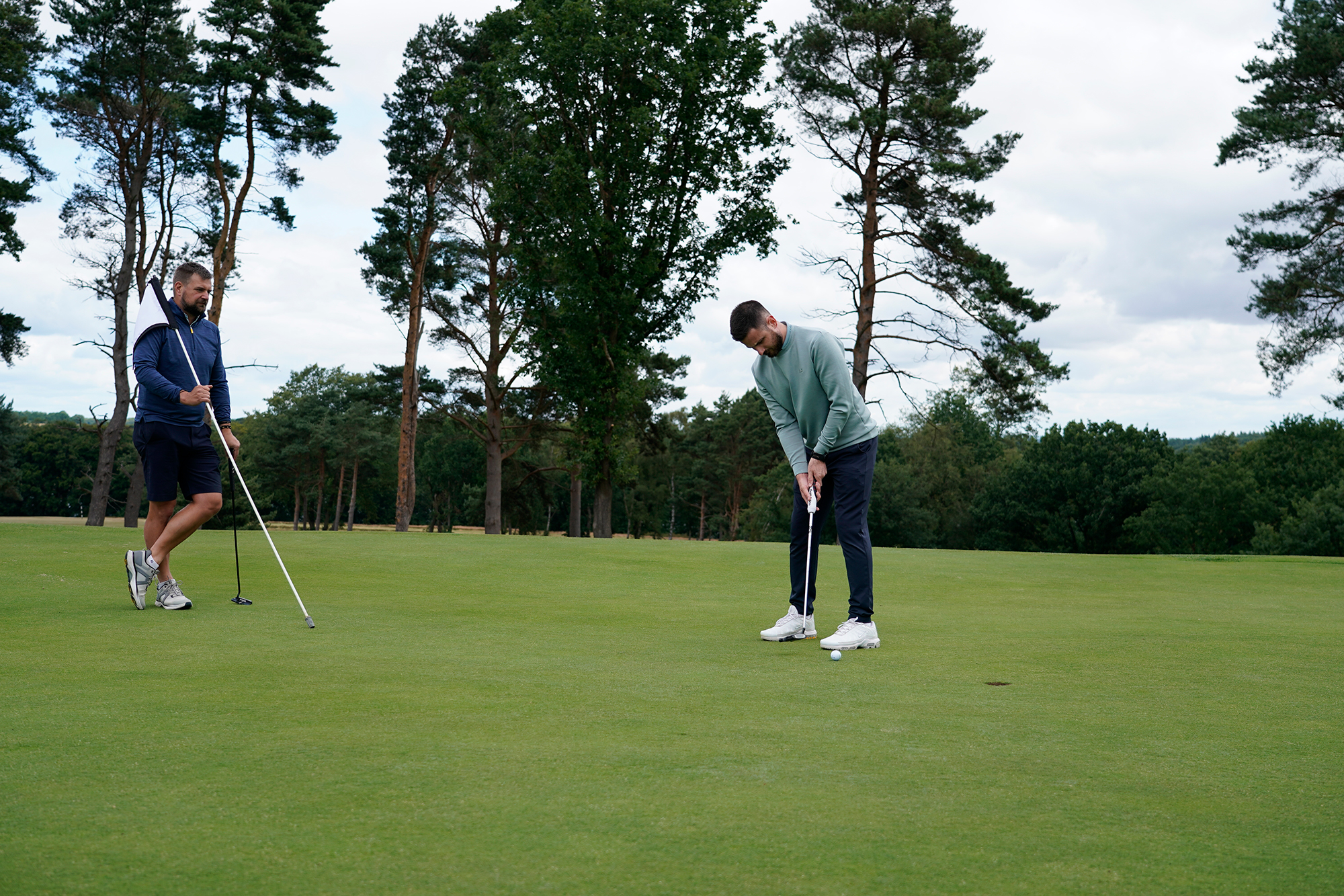 Baz Plummer hitting a short putt on the 9th green at Sand Moor Golf Club