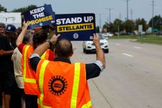 Stellantis UAW workers on strike, holding up signs at rally in Sterling Heights, Michigan