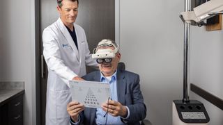A patient wearing the OcuLenz vision-enhancement headset