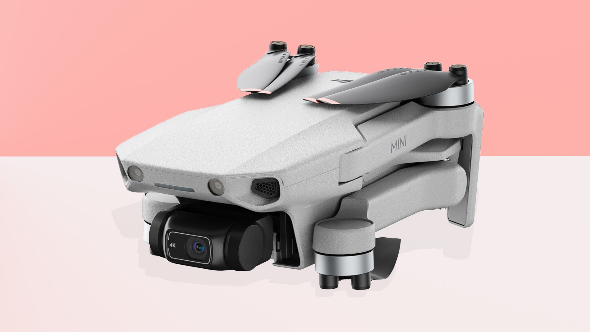 The DJI Mini 2 drone on a pink and grey background