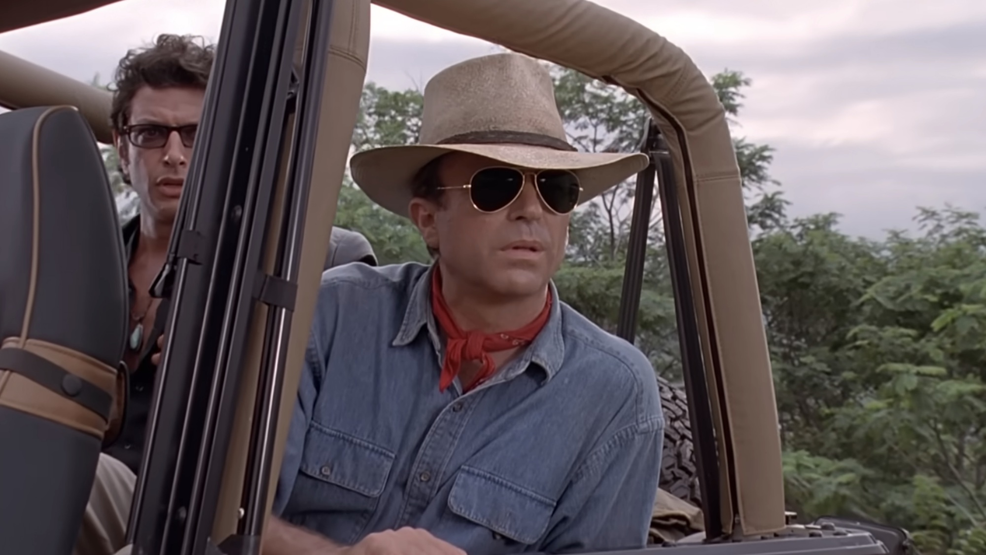 Sam Neill in a jeep in Jurassic Park.