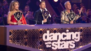 From left to right, CARRIE ANN INABA, DEREK HOUGH and BRUNO TONIOLI all holding up their six scores.