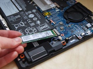 Remove the old SSD from the slot.