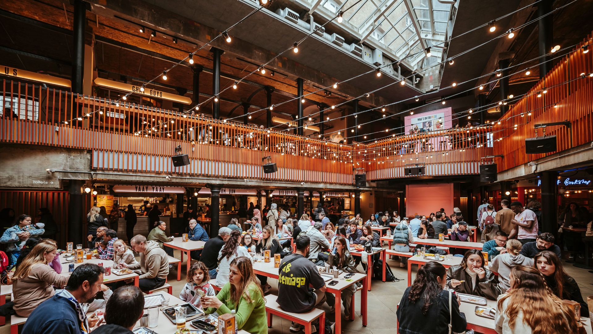 an image of the interior of the Seven Dials Market showing the open dining area on the ground floor