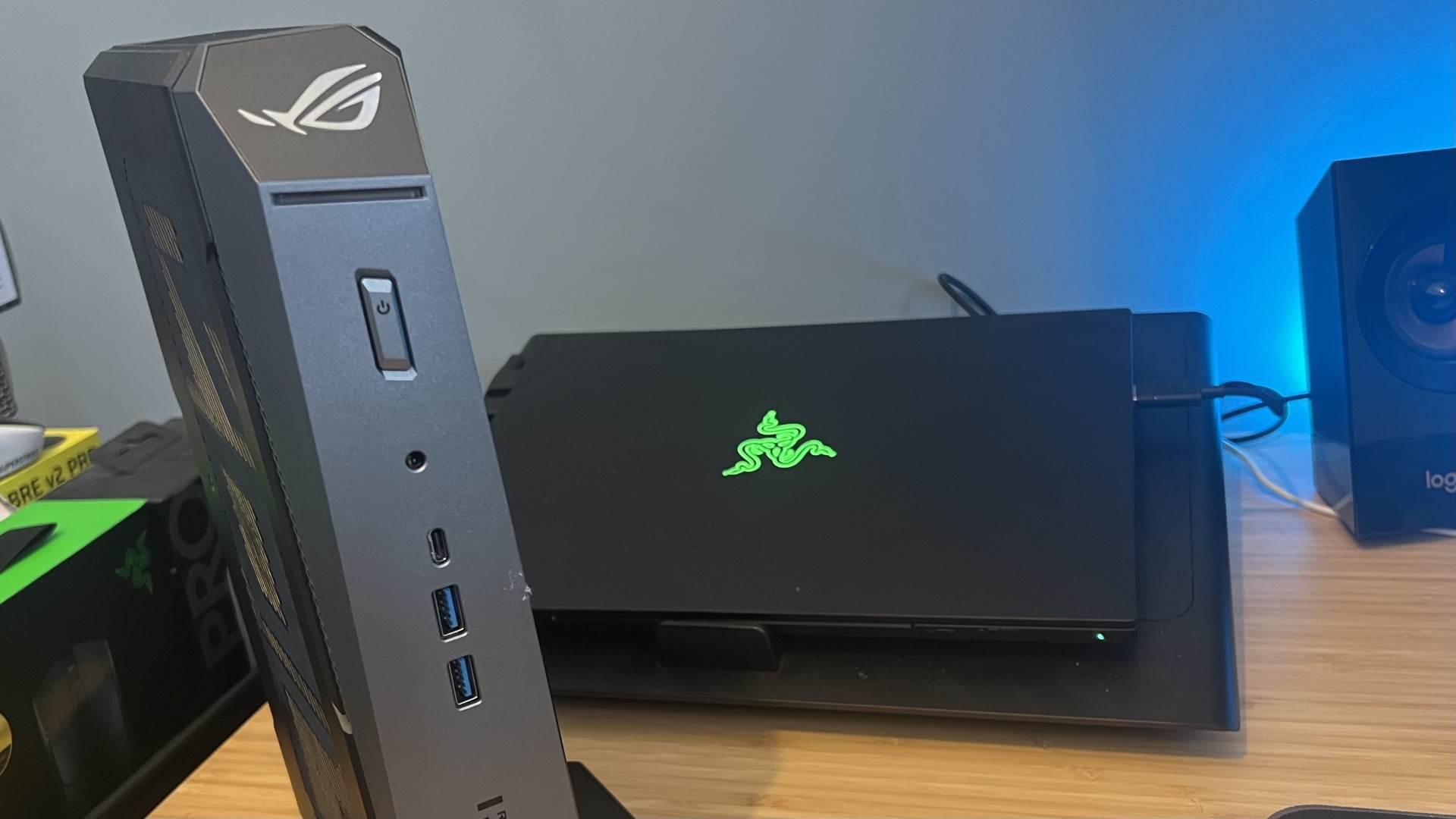 Asus ROG NUC mini PC in front of a Razer Blade 14 gaming laptop