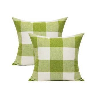 Two white and lime green checked outdoor throw pillows, with one in front of the other