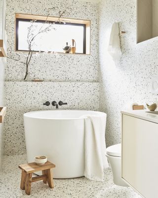 a small bathroom with a small rounded tub