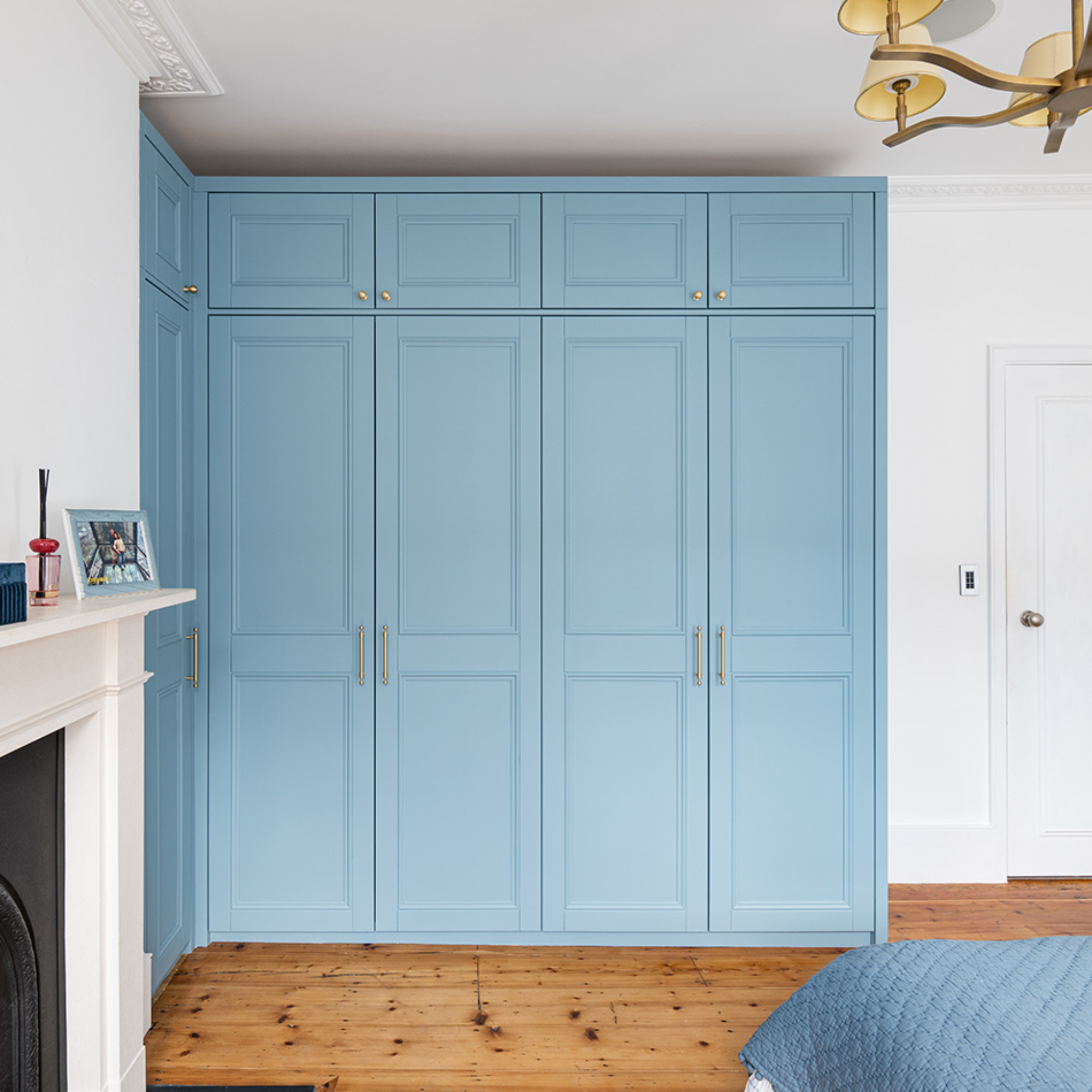 blue fitted wardrobes in a bedroom