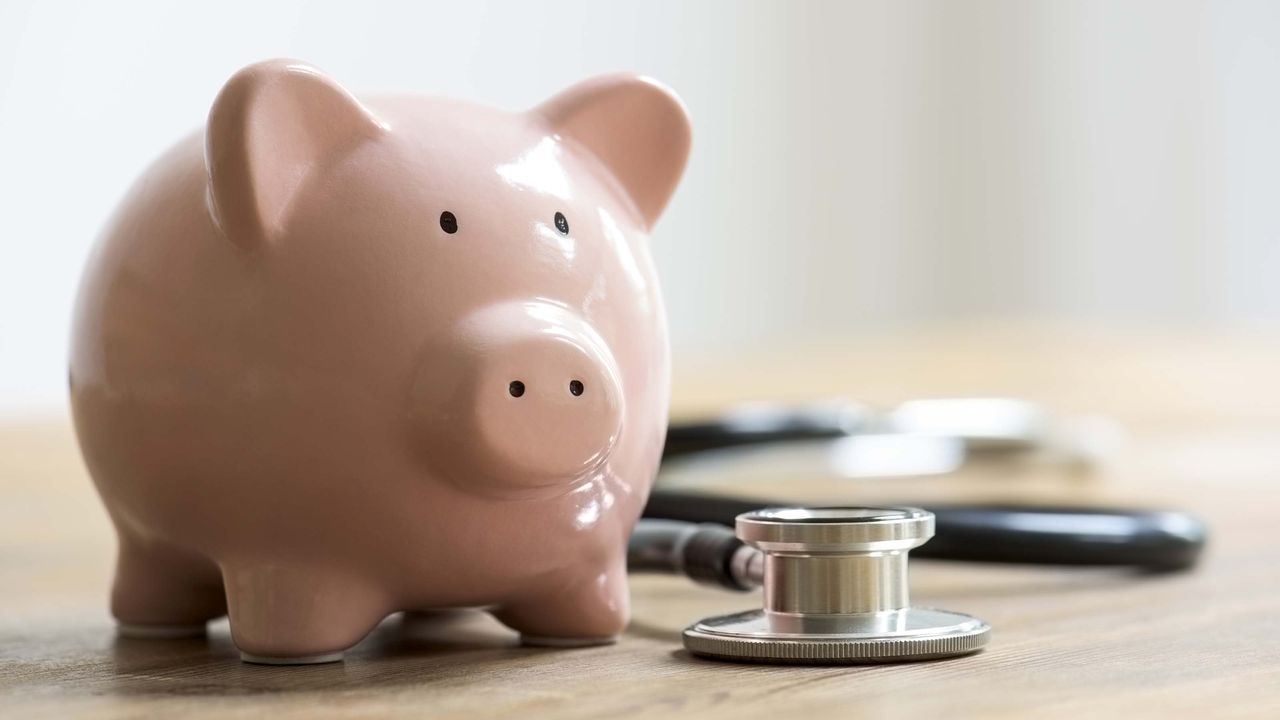 Piggy bank near stethoscope