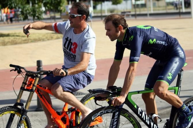 A fan guides Alejandro Valverde (Movistar Team) to the anti doping control, and uses the moment to take a selfie. A scrum of chaperones were running after them