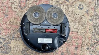 Roborock Saros 10R robot vacuum and mop flipped over to show underside