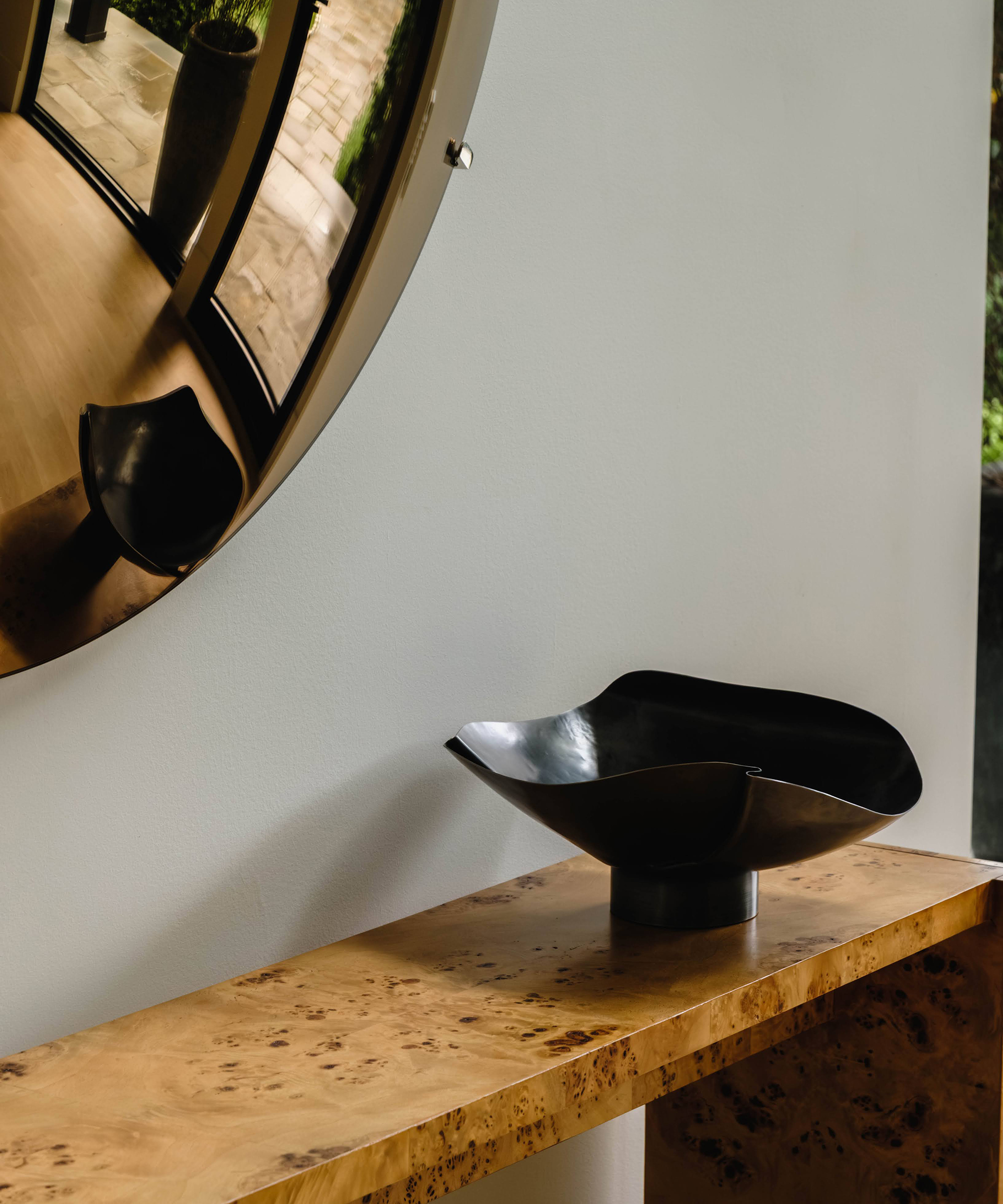 entryway console with sculptural bowl on it