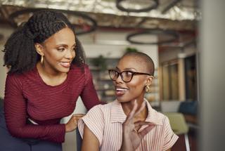 Women, collaboration and okay sign at computer for planning, success and discussion of positive feedback in office. Happy business people smiling at desktop for agreement, approval or yes to strategy