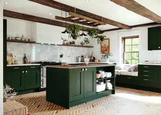 A country kitchen with dark green cabinets and white wall tiles