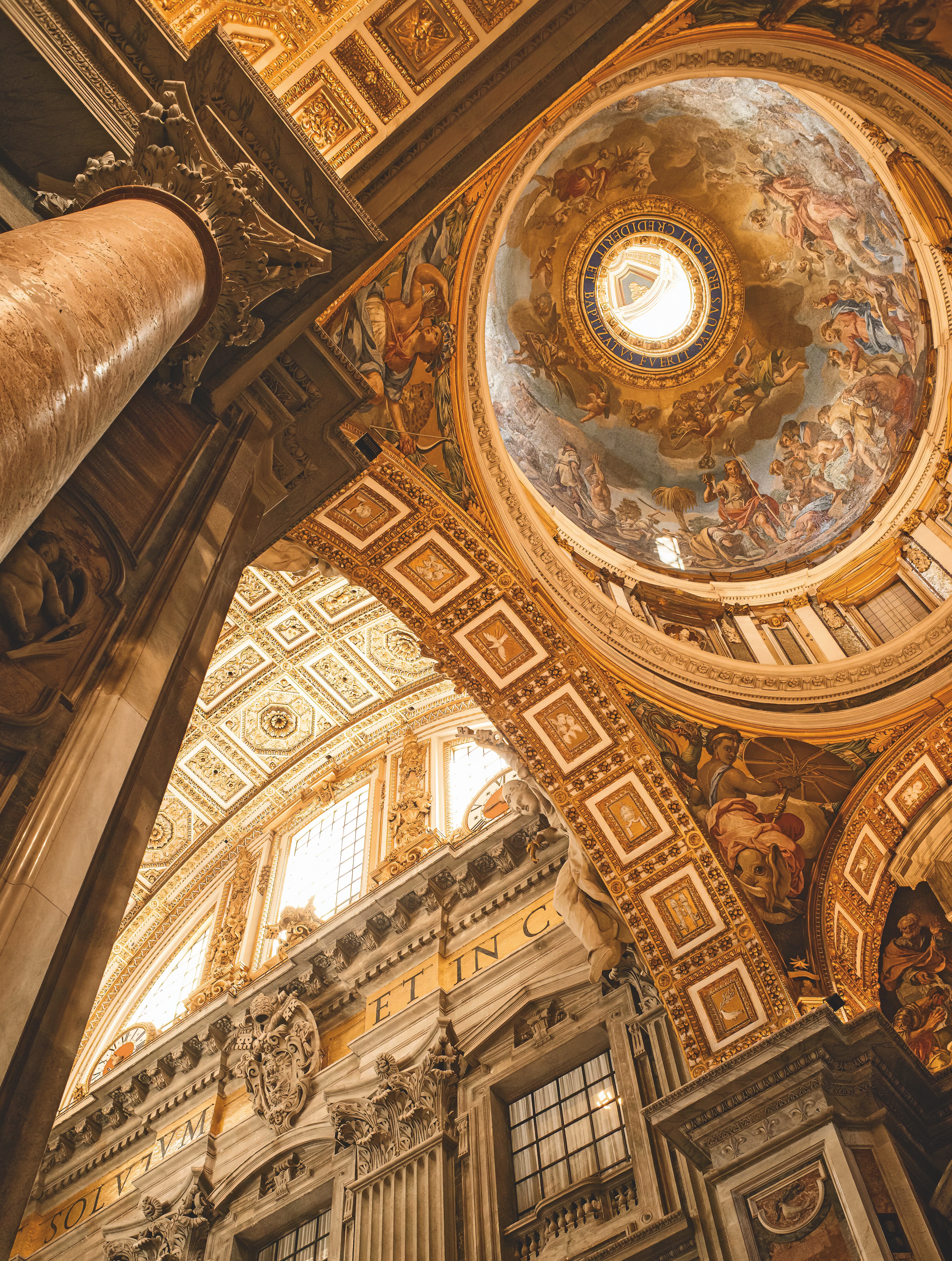 Upward view of a church's frescoed ceiling in Rome