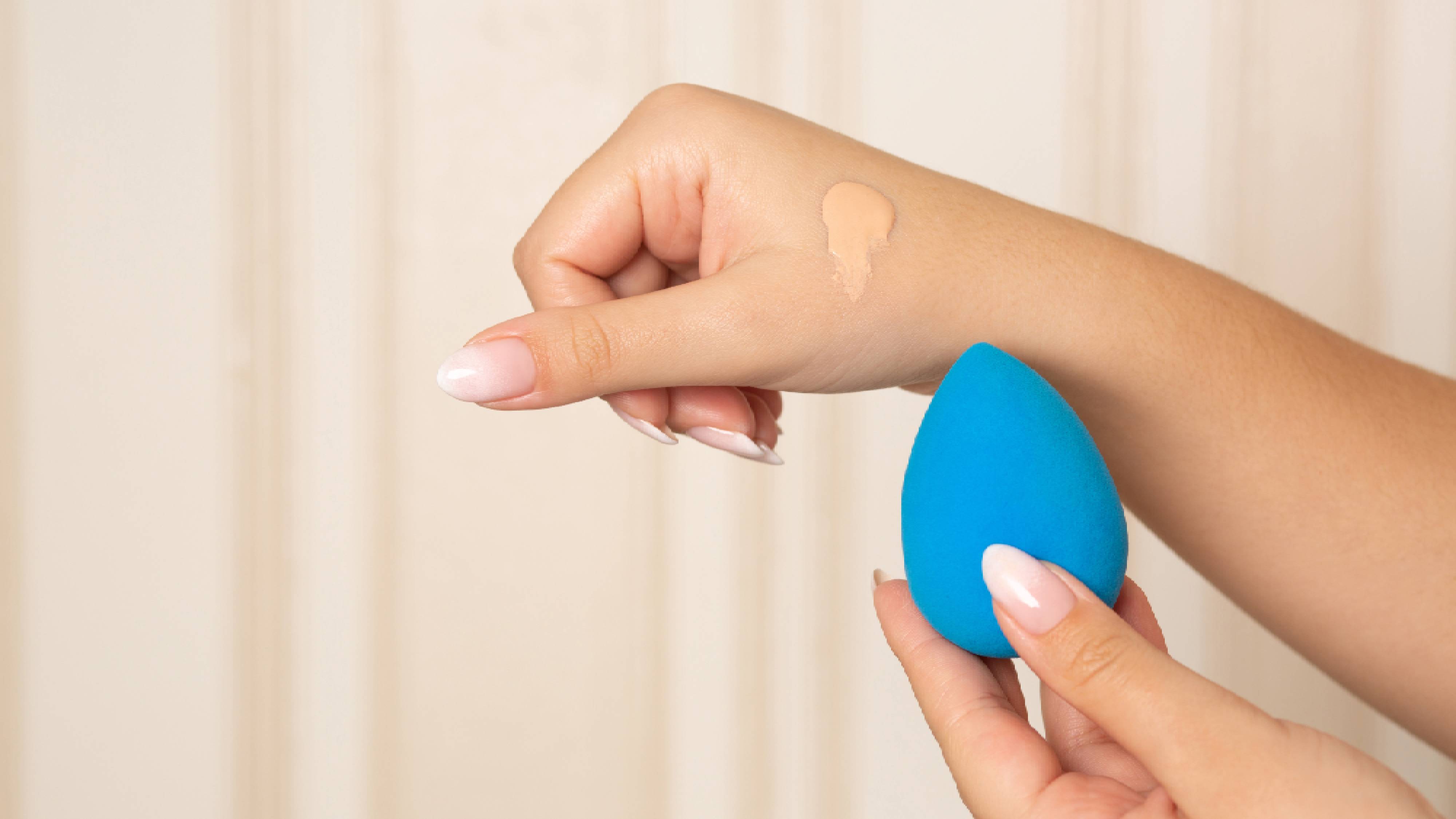 CC cream being applied with a beauty blender