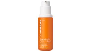Ole Henriksen Banana Bright Vitamin C serum, in a on orange bottle with a white lid and white writing, picked as the best vitamin c serum by our beauty team
