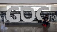 An attendee sits next to a "GDC" sign inside an exhibition hall during the Game Developers Conference at the Moscone Center in San Francisco, California, U.S., on Tuesday, March 22, 2022. The weeklong video game industry conference is San Francisco's biggest convention since public health orders upended the events business two years ago, reported the San Francisco Chronicle.