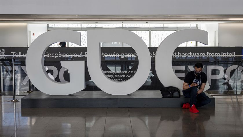 An attendee sits next to a "GDC" sign inside an exhibition hall during the Game Developers Conference at the Moscone Center in San Francisco, California, U.S., on Tuesday, March 22, 2022. The weeklong video game industry conference is San Francisco's biggest convention since public health orders upended the events business two years ago, reported the San Francisco Chronicle.